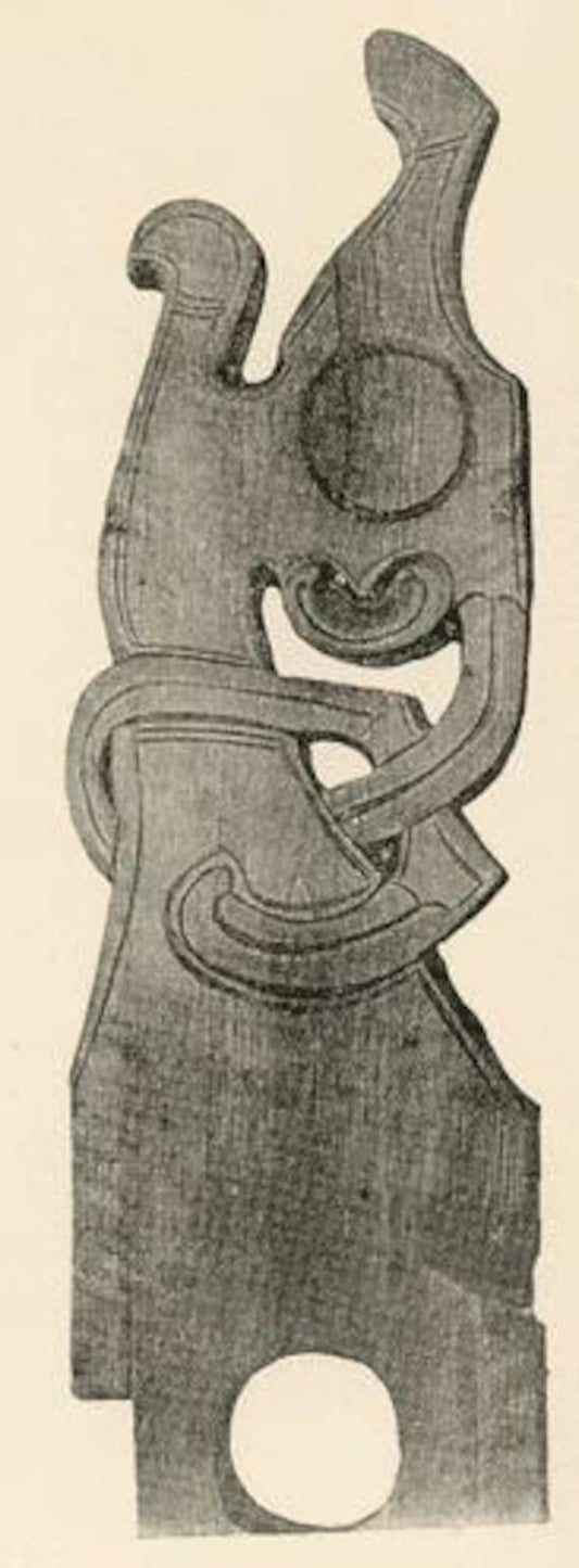 Wooden carvings with abstract designs on a plain background