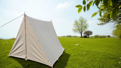 White tent on a grassy field with trees in the background