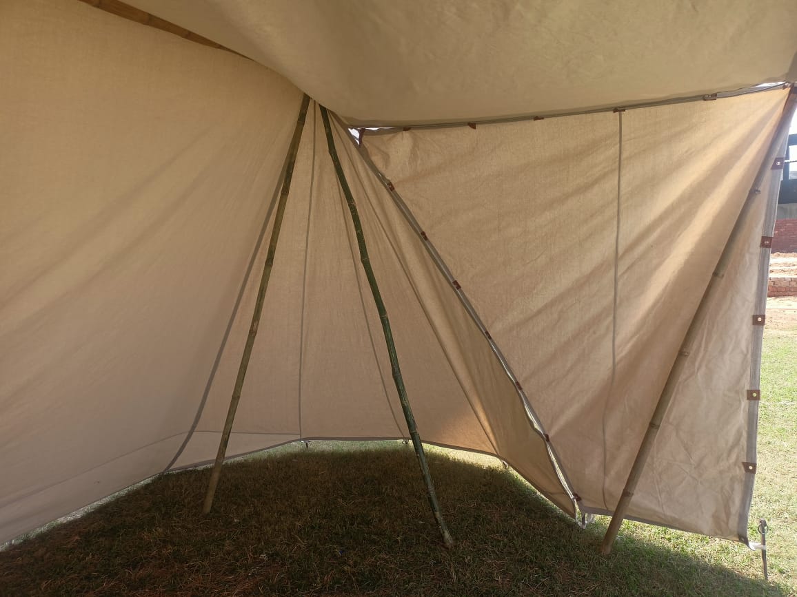 Beige tent with a grassy background