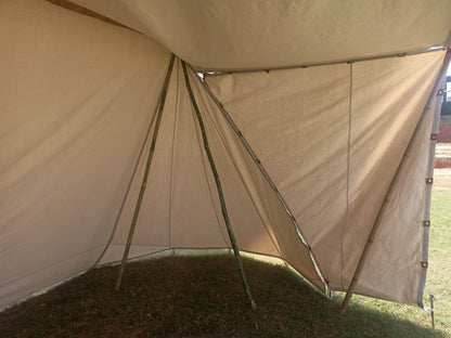 Beige tent with a grassy background