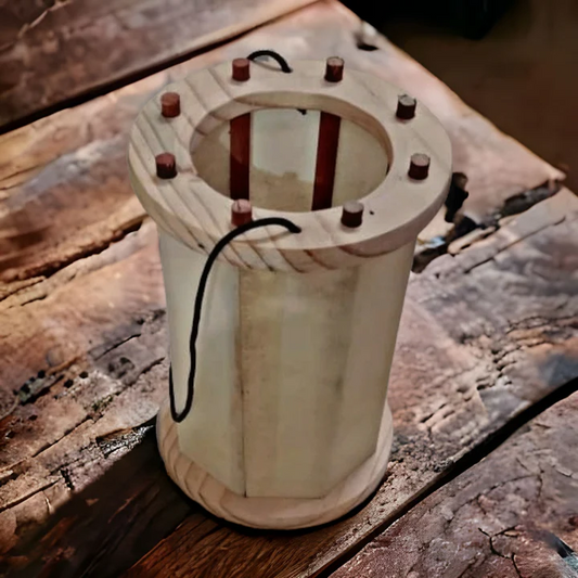 Wooden spool with a cylindrical core and wooden top on a rustic wooden surface