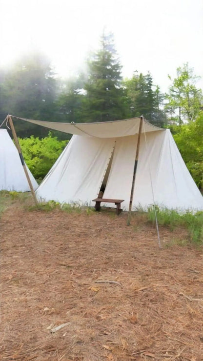 White canvas tent with a wooden bench in a forest setting