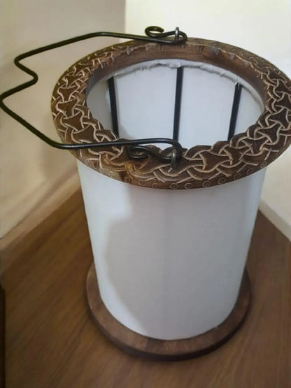 Decorative lamp with intricate metalwork on a wooden surface