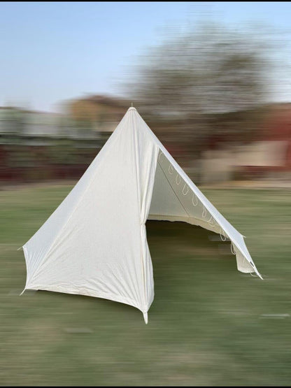 White tent on a grassy field with a blurred background