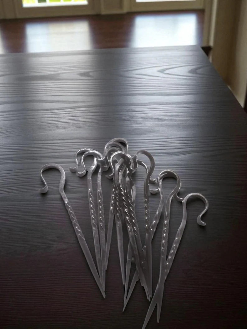 Metal hooks on a dark wooden surface