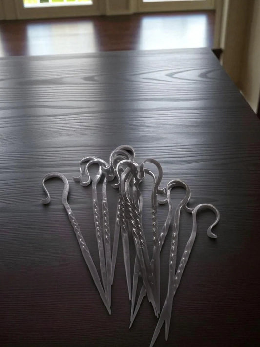 Metal hooks on a dark wooden surface